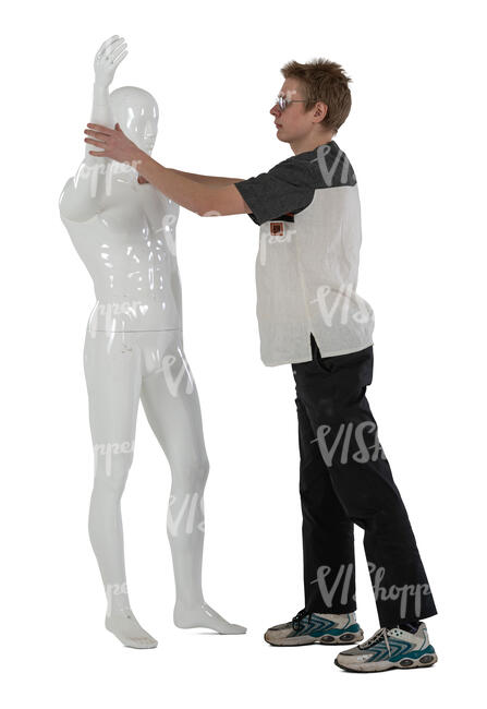 young man fixing a life size mannequin