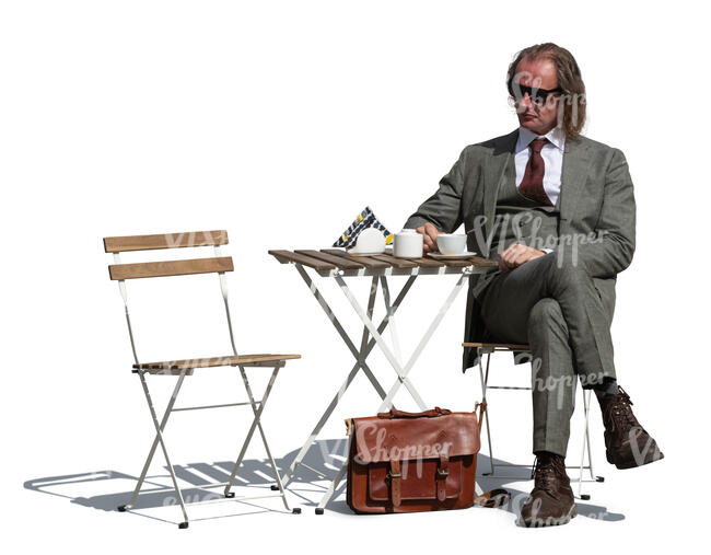 cut out man in a suit sitting in an outdoor cafe