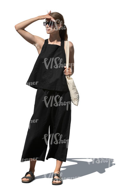 woman in a black summer outfit standing and looking