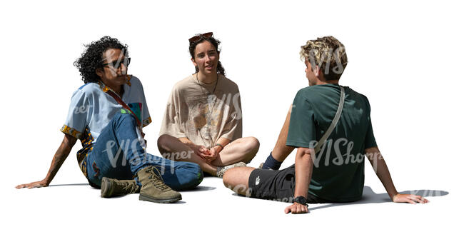 group of three people sitting on the ground