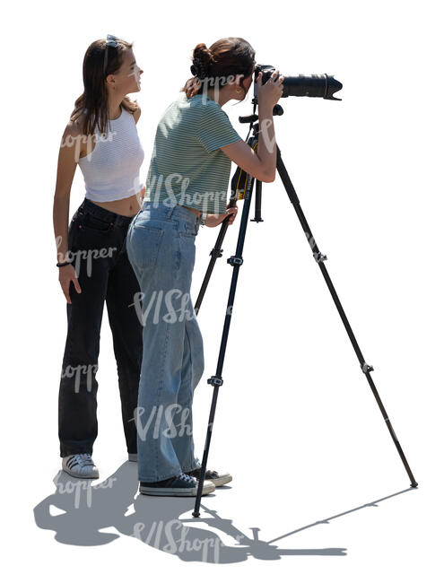 cut out backlit image of two women with a photo camera