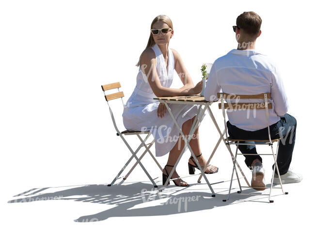 backlit elegant couple sitting in a restaurant