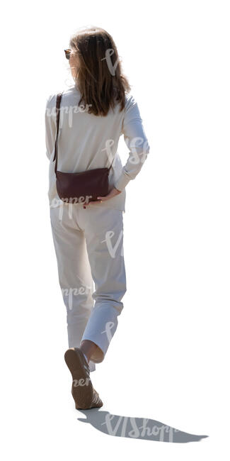 cut out backlit woman in white outfit walking