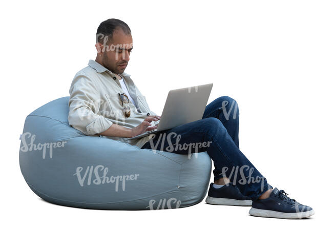 man sitting in a bean bag chair with laptop