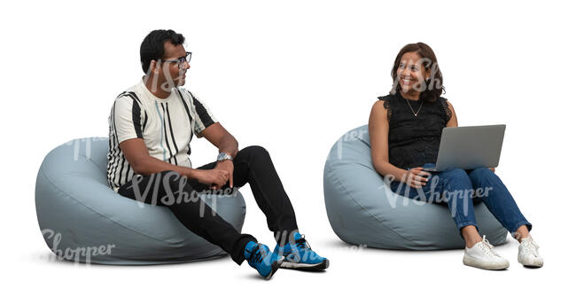 man and woman sitting on bean bag chairs and working with computer