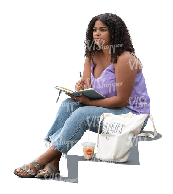 young black woman sitting and writing in her notebook