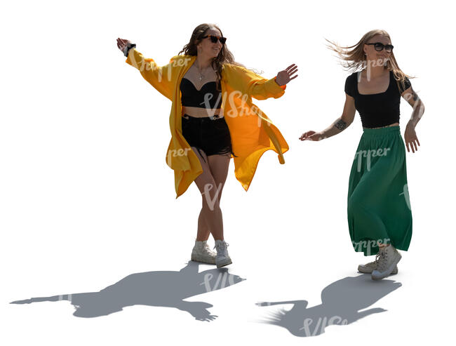 two backlit women dancing