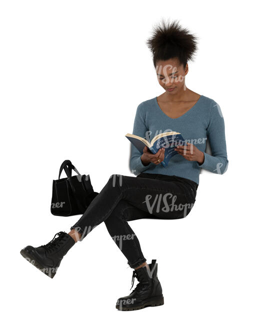 young black woman sitting and reading a book