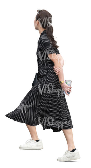 cut out asian woman in a dress walking up the stairs