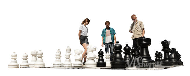 three people playing giant outdoor chess