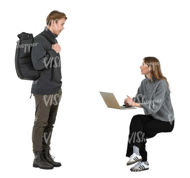 woman sitting and talking to a man with a backpack standing