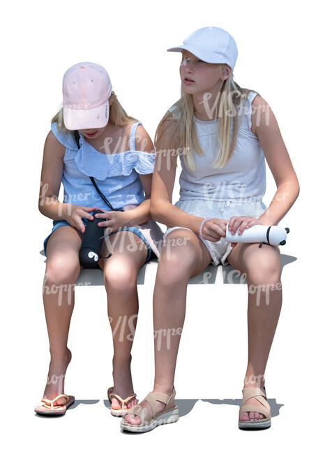 two little girls sitting in partial light