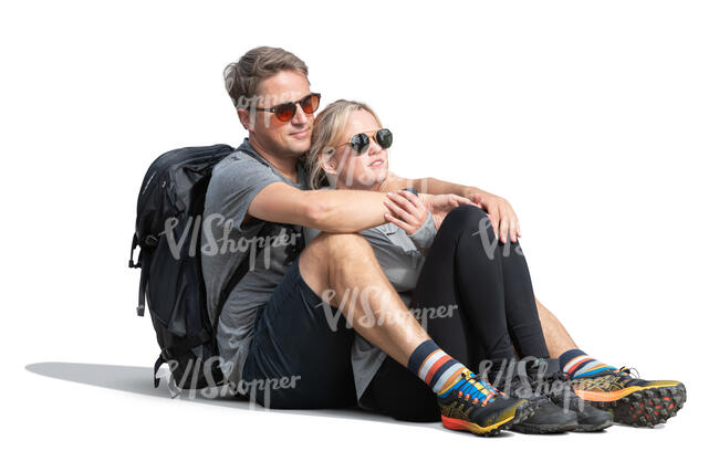 man and woman sitting together on the ground and admiring the view