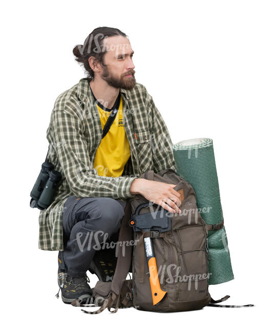 male hiker with backpacks squatting