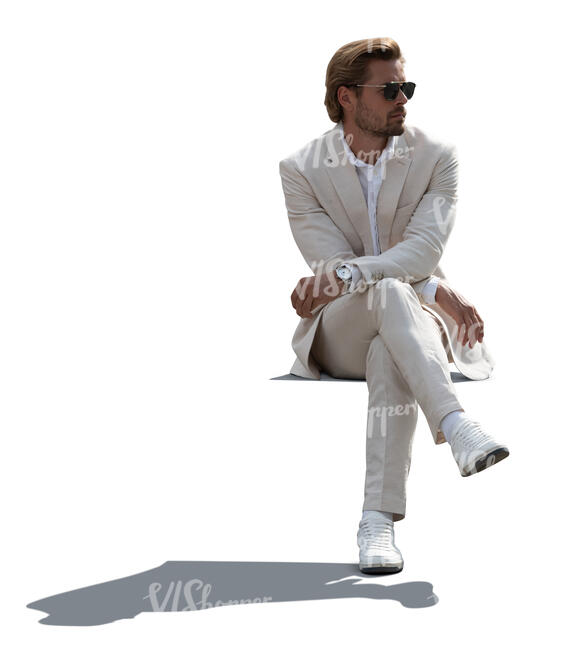 cut out backlit man in a white suit sitting