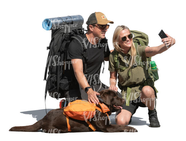 two hikers and a dog taking a selfie