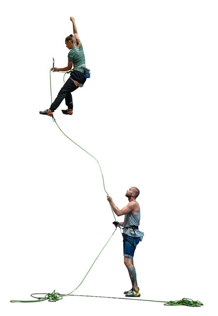 rock climbing team climbing on a climbing wall