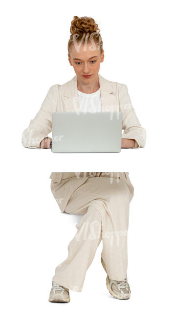 woman in a trendy white suit sitting behind the desk