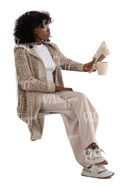 woman wearing a comfy cardigan sitting and reading a book