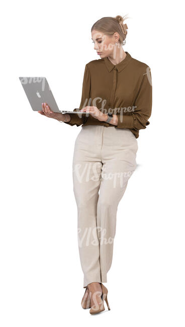 woman leaning against the desk and looking at her laptop