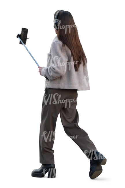 woman with a selfie stick walking and recording - VIShopper