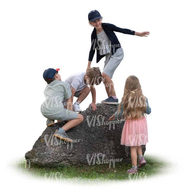 children climbing on a big rock