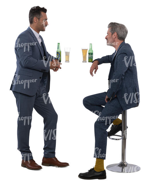 two men in suits sitting in a bar and talking