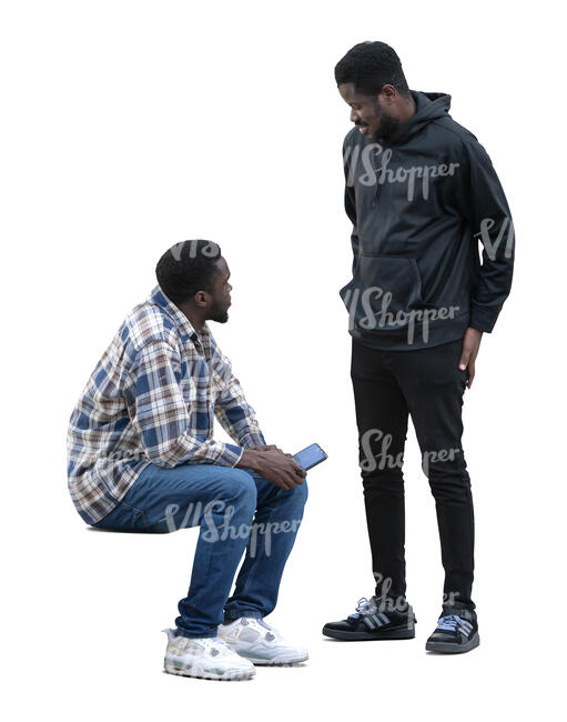 two black men sitting and talking