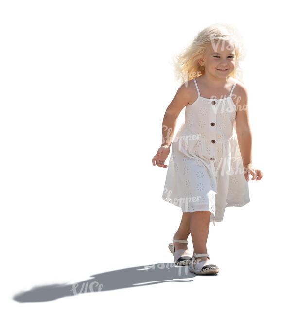 backlit little girl in a summer dress walking