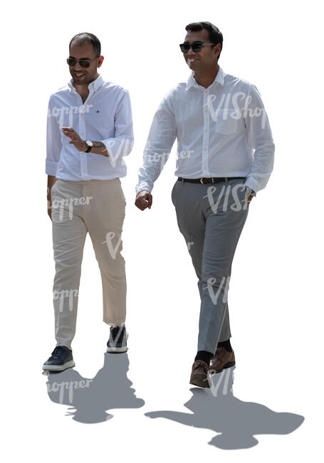 two backlit men in white shirts walking