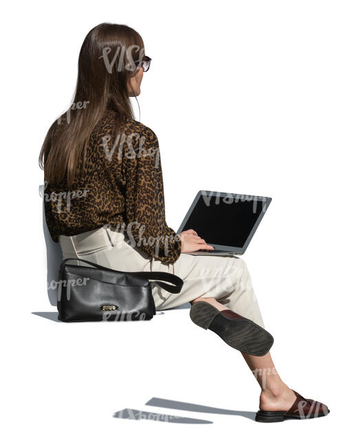 woman with a laptop sitting outside