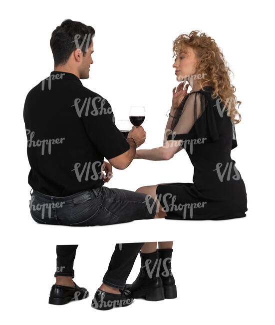 man and woman sitting in a restaurant and drinking wine