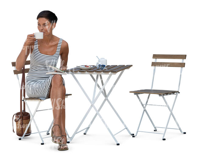 woman in a striped dress sitting in a cafe and drinking coffee