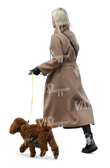 woman in a brown overcoat walking a dog