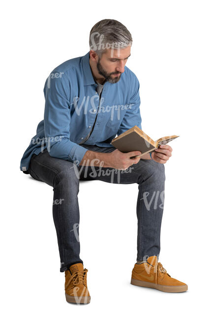 man sitting and reading a book