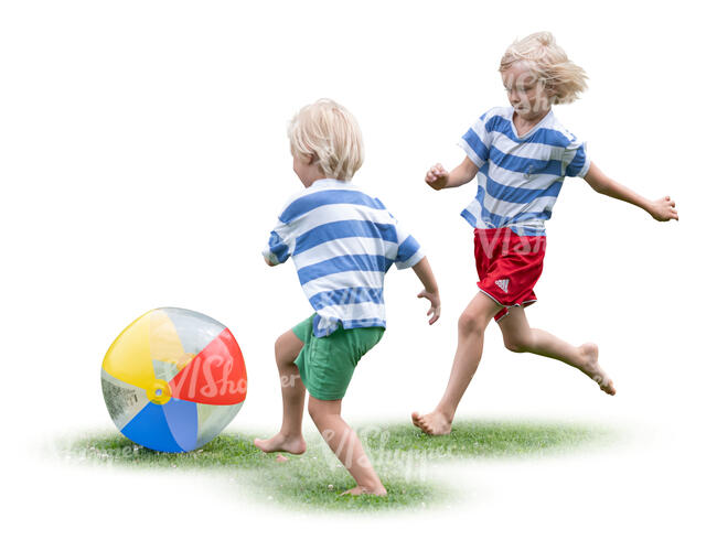 two boys playing with a ball on the grass