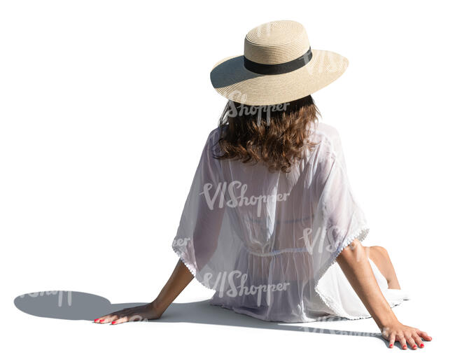 woman with a hat and in a light summer dress sitting