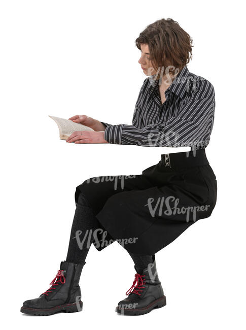 woman sitting at a desk and reading a book