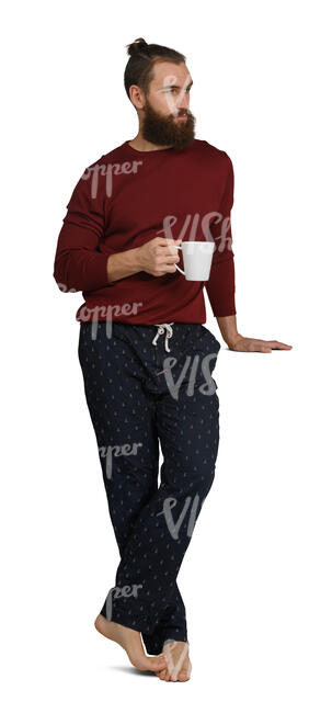 man standing in the kitchen and drinking coffee