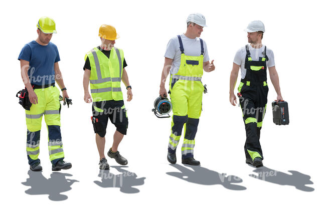 group of backlit construction workers walking