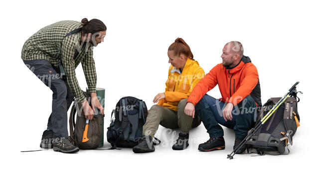 cut out group of hikers sitting and unpacking hiking gear