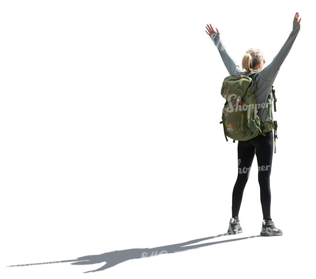 backlit woman with hiking backpack standing arms stretched out