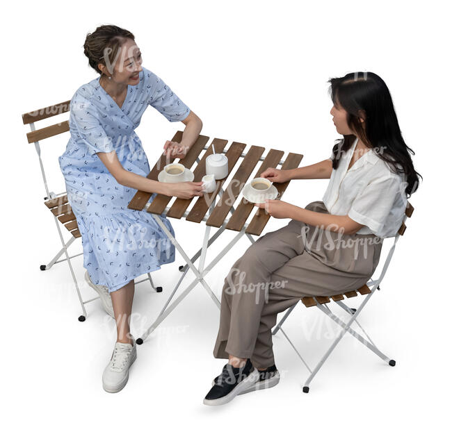 two cut out asian women sitting in a cafe seen from above