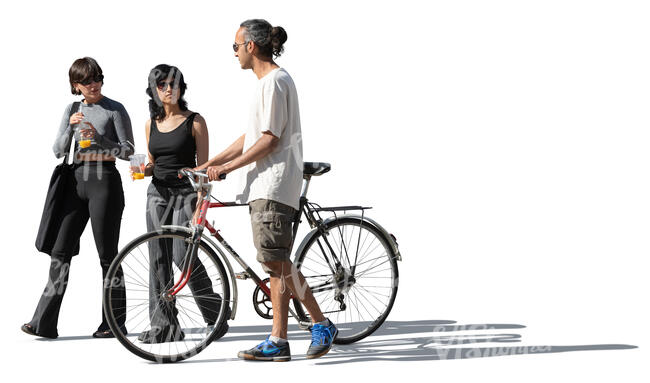 group of three friends walking in the street with a bike and soft drinks