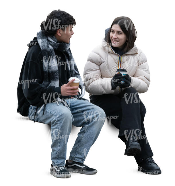 two cut out people sitting outside in winter and drinking hot drinks