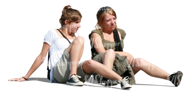 two women sitting on the ground