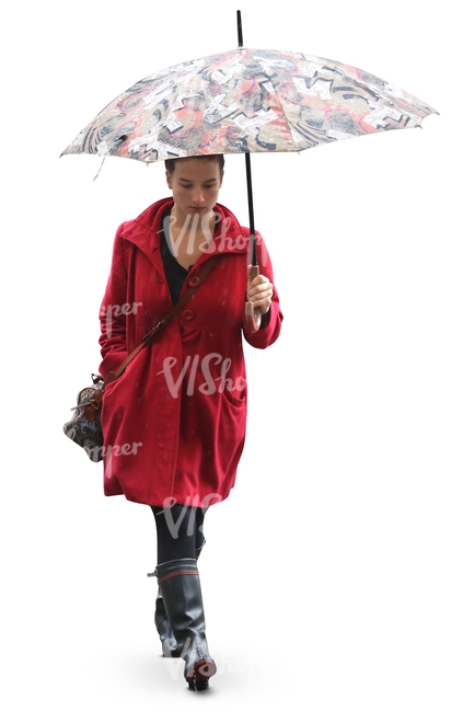 woman in a red coat and wellies walking under an umbrella