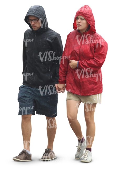 couple in raincoats walking hand in hand in the rain