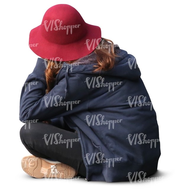 girl with a red hat sitting on the ground