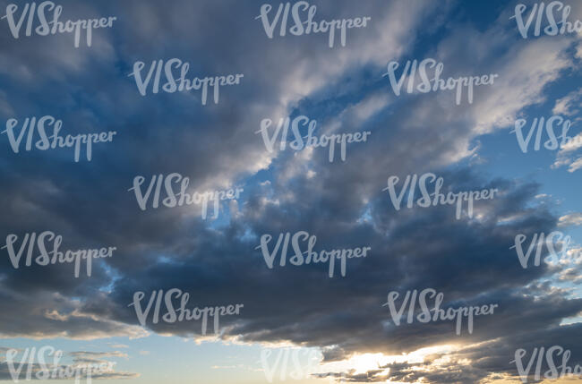 evening sky with sun low behind the clouds